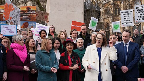 Alison Bennett MP speaking to campaigners outside parliament who are protesting for carers