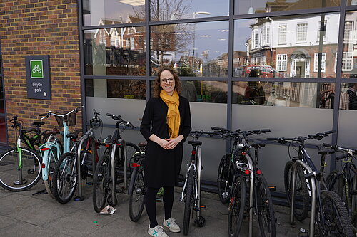 Alison outside bicycle parking.