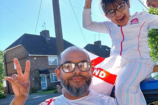 Billah in an England Shirt with his daughter