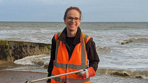 Alison helping clean a beach