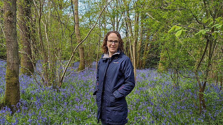 Alison standing among bluebells