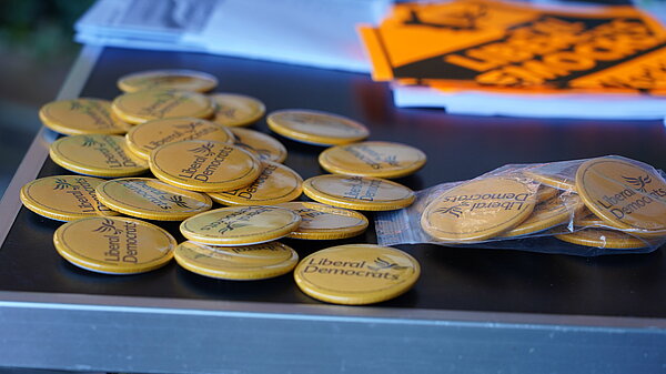 Lib Dem badges on a table