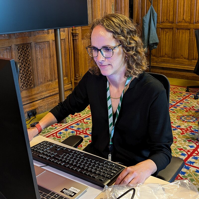 Alison on a computer in Parliament
