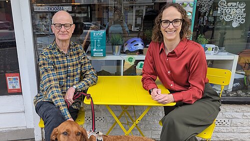 Iain and Alison sitting outside cycling shop in Hassocks