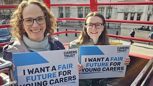Alison Bennett MP holding sign saying I want a fair future for young carers with another activist holding a similar sign