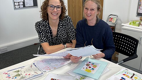 Alison and Kate looking at the entries